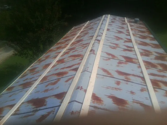 Rusted metal roof panels with new wood purlins before replacement — Storm Damage Roof Repair in Kalama by Roofing Brothers
