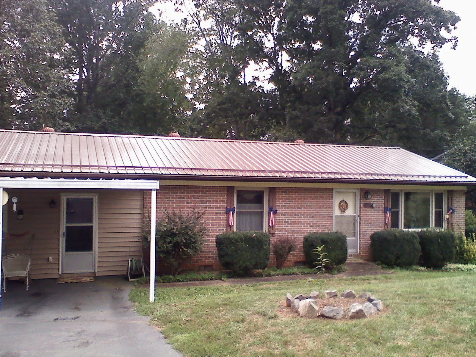 Bronze metal roof and carport on a brick ranch home — Roof Repair work by our crew in Kalama